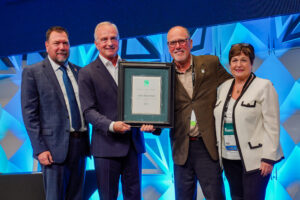 Pictured is Mike Pfeiffer receiving the 2022 Bobby J. Fowler Award alongside Michael Wich, Dominic Sims, and Cindy Davis