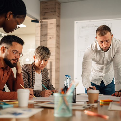 people in an office gathered around a table