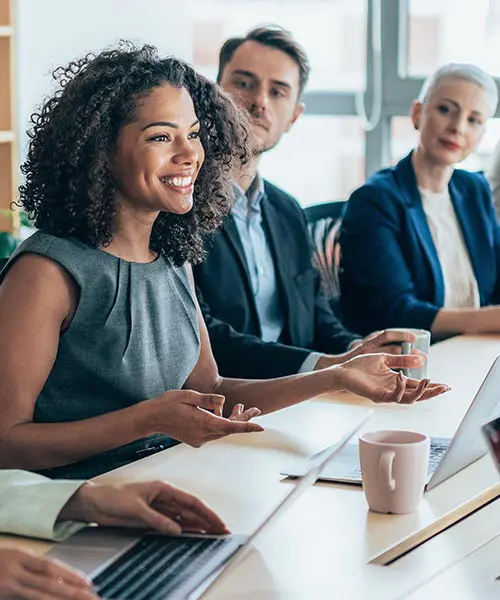 several people sitting around a conference table in a meeting