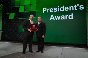 International Code Council Board Immediate Past President Jay Elbettar (right) presents his 2018 ICC President's Award to the membership. Board Director Tom Peterson accepts the award on behalf of the ICC membership.