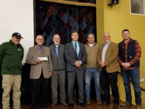 Picture of the presentation of the check donation for the Kentucky flood support