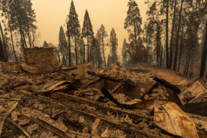 A community of forest homes lies in ruins in the Meadow Lakes area after the Creek Fire swept through Shaver Lake, Calif. A state of emergency has been declared in five California counties and applies to Fresno, Madera and Mariposa, San Bernardino, and San Diego counties. Photo: David McNew/Getty Images