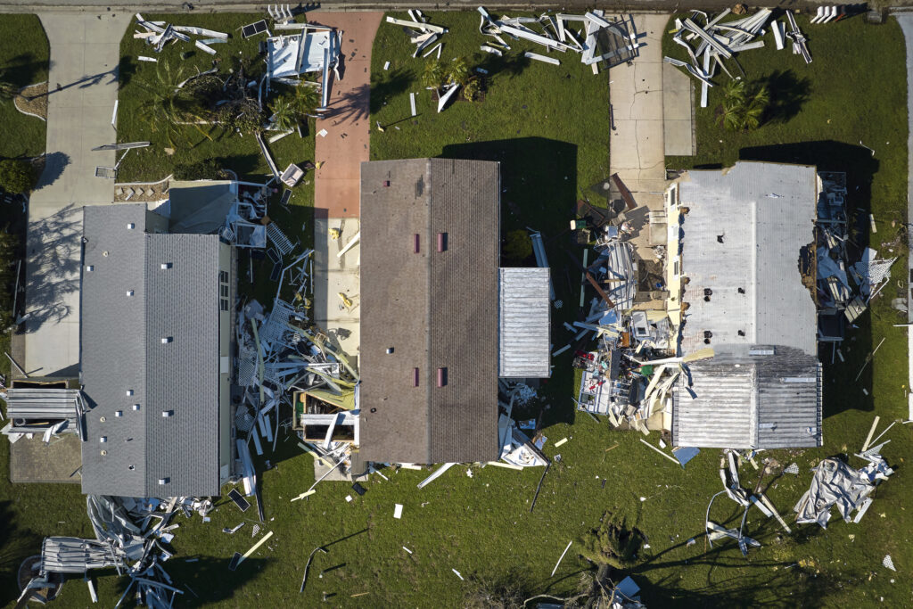 Hurricane Ian destroyed homes in Florida residential area. Natural disaster and its consequences.