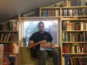 Glenn Mathewson, Master Code Professional turned consultant, displays some of the 450 codebooks he has collected at his home near Denver.