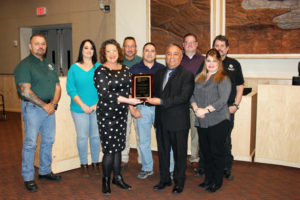 Front row from left, Kellee Fernandez of IAS, left, holds up the IAS accreditation plaque along with the Community Development Department building staff, which includes Chief Building Official Michael Arellano and Lenora Maes. Back row from left, building staff David Martinez, left, Adrienne Lovato, Larry Valdez, Michael Marquez, Department Director Paul Andrus and Joe Dudziak. Photo by Kirsten Laskey