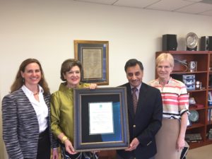 Senior Vice President of ICC Government Relations Sara Yerkes presents a plaque to ANSI President and Chief Executive Officer S. Joe Bhatia on May 17. Pictured, from left, ICC Vice President of Global Activities Judy Zakreski, Yerkes, Bhatia and ANSI Vice President of Government Relations Mary Saunders.