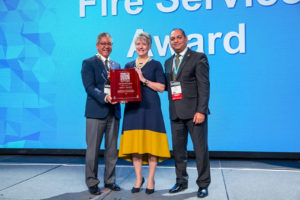 2018 Fire Service Award recipient Tonya Hoover (center) with ICC Board Immediate Past President Jay Elbettar (right) and ICC Awards Committee Chair Stuart Tom (left).