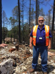 Lucas Chapman stands by the remains of his burned-down home.