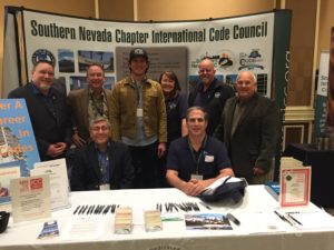 Ramon Fajardo with chapter leaders in the EduCode/Southern Nevada Chapter of ICC exhibit. From left (standing): International Code Council Board Director Jim Sayers, Chapter Past President Sam Palmer, Fajardo, Chapter President Terry Kozlowski, and International Code Council Government Relations Senior Regional Manager David Nichols (seated): Industry Board Member Mo Jadid and EduCode Director Al Ellis.