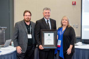 Pictured is Rademacher (center), program manager of the Viega Trades Education Network, as he accepts the 2021 PMG Leadership Award from ICC Awards Committee Chair Shirley Ellis (right) during the PMG Membership Council meeting on Sunday, Sept. 19, 2021, in Pittsburgh, Pennsylvania.