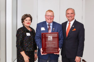 ICC Region II President Jack Applegate (center) receives the 2018 ICC Raising the Profile Award from ICC Government Relations Senior Vice President Sara Yerkes (left) and ICC Chief Executive Officer Dominic Sims (right).