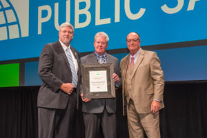 Bill McKinney (center) receives the 2019 Excellence in Public Safety Award from Committee Chairman Alan Boswell (left) and Code Council Board Immediate Past President William Bryant (right) during the ICC Members Luncheon on Oct. 22, 2019, in Las Vegas, Nev.