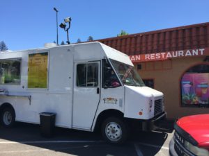 A mobile food truck sits next to the Mexican restaurant that was spared by the fire, but still can’t be used by customers because of the contaminated water.
