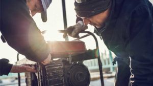 Workers repairing a power generator.