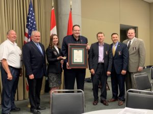 Daniel Finnegan (center) receives the 2019 Excellence in Fire and Life Safety Award. From left, ICC Board Past President, former Georgia State Fire Marshal, and recipient of the 2018 Excellence in Fire and Life Safety Award Dwayne Garriss; former Tennessee State Fire Marshal and chair of the ICC Fire Service Membership Council Gary West; ICC Board Director and fire safety manager for St. Paul, Minn., Angie Wiese, P.E., CBO; IAFC President and fire chief for Albermarle County, Va., Dan Eggleston; IAFC International Director and fire chief for the Brighton Area Fire Department, Mich., Michael O’Brian; and IAFC Fire and Life Safety Section Chair and deputy fire chief-fire marshal for Franklin, Tenn., Andy King