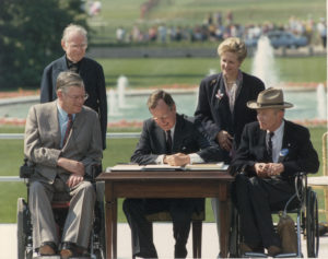 George Bush signs the Americans with Disabilities Act of 1990 on July 26, 1990, in Washington, D.C.