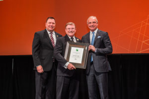 Randy Noel (center) receives the 2019 ICC Meritorious Service Award from Code Council Board of Directors Secretary/Treasurer Michael Wich (left) and Code Council Chief Executive Officer Dominic Sims (right) during the ICC Annual Banquet on Oct. 22, 2019, in Las Vegas, Nev.