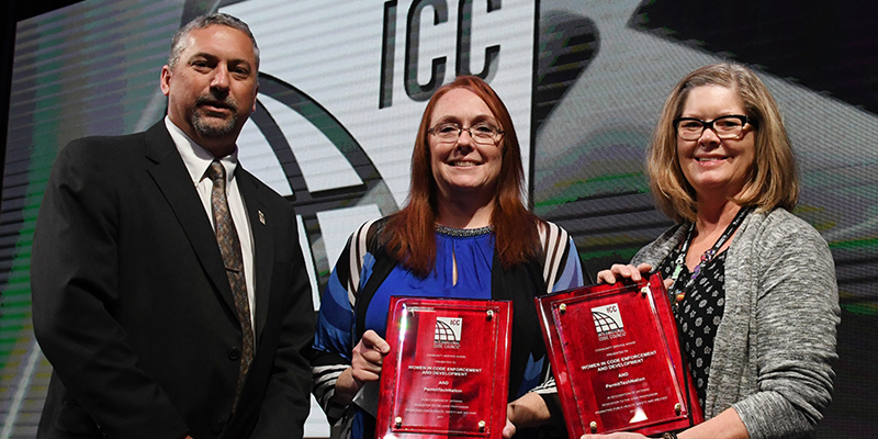 Accepting the 2017 ICC Community Service Award from Awards Committee Chairman Richard Truitt (left) on behalf of WICED and PermitTechNation are Amber Armstrong (center) and Cindi Somers (right).