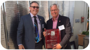 International Code Council Board of Directors President Alex Olszowy, III, with the Lexington Fayette County Government in Lexington, Ky., presents the ICC Raising the Profile Award to Tom Phillips (right) of Target Corp., during the annual Building Safety Month reception at the ICC office in Washington, D.C.